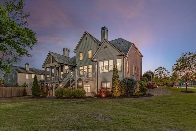 895 Ovalene Ln SW, Marietta, GA 30064 - back of property at dusk with a lawn, a chimney, and fence