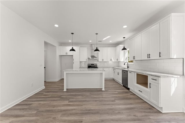 kitchen featuring pendant lighting, white cabinets, a kitchen island, stainless steel appliances, and light hardwood / wood-style flooring