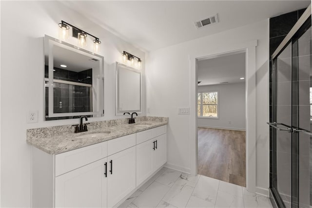 bathroom with an enclosed shower and vanity