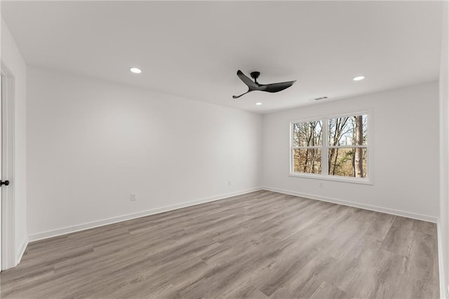 spare room featuring ceiling fan and light hardwood / wood-style floors