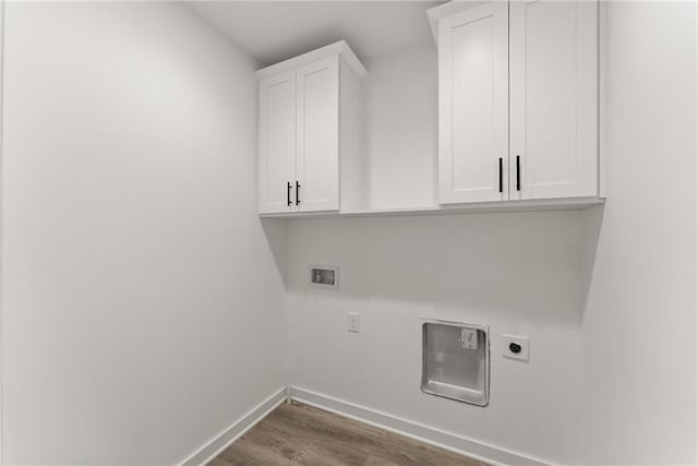 washroom featuring washer hookup, cabinets, wood-type flooring, and electric dryer hookup