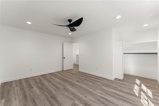 unfurnished bedroom with ceiling fan, a closet, and light hardwood / wood-style flooring