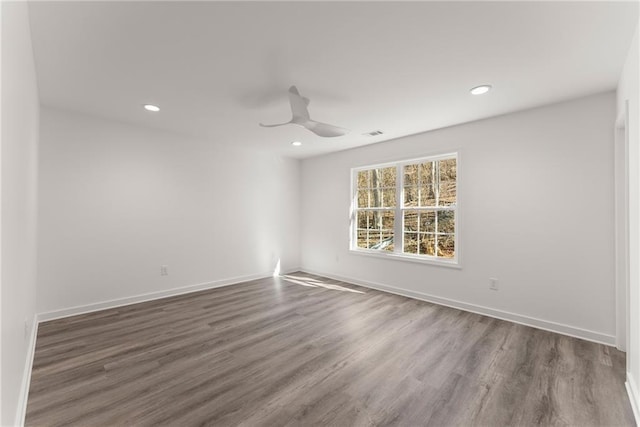 unfurnished room with ceiling fan and dark wood-type flooring