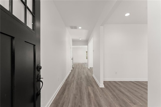 hallway with wood-type flooring