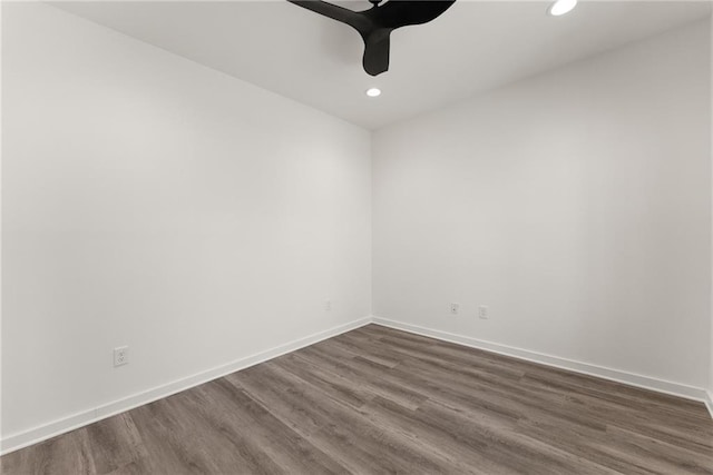 empty room featuring ceiling fan and dark wood-type flooring