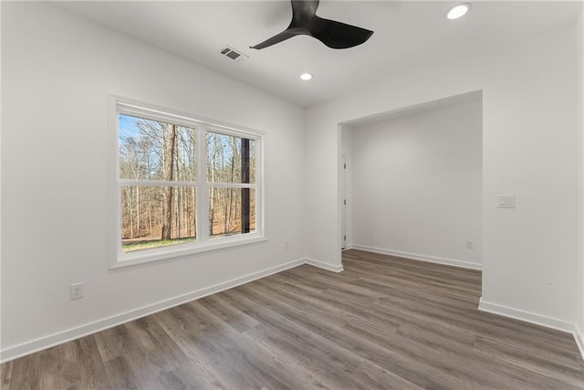 empty room with ceiling fan and hardwood / wood-style floors