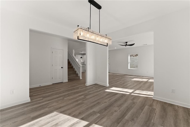 unfurnished dining area with ceiling fan and hardwood / wood-style flooring