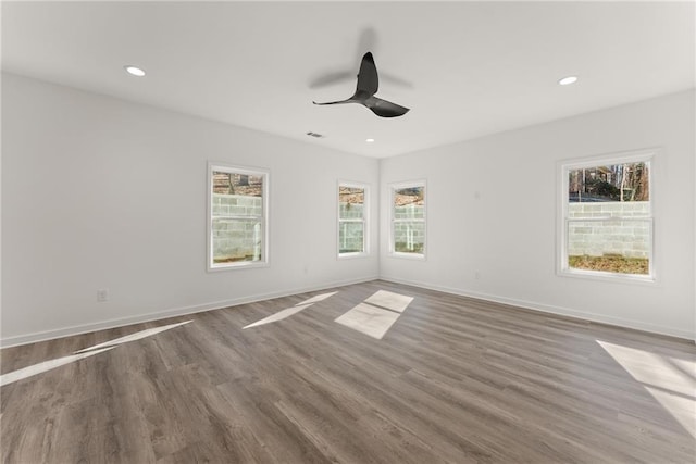 spare room with ceiling fan and dark hardwood / wood-style flooring