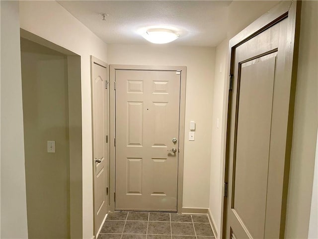 doorway featuring a textured ceiling