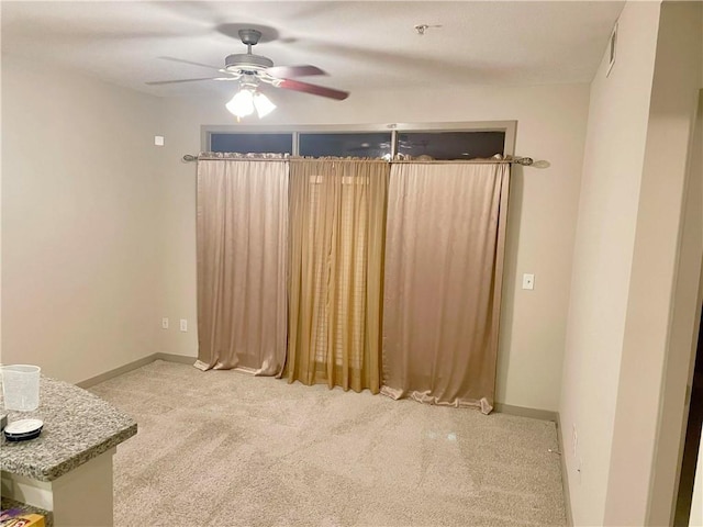 carpeted empty room with ceiling fan