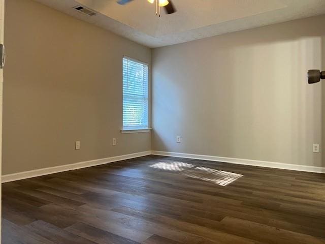 unfurnished room with dark hardwood / wood-style floors and ceiling fan