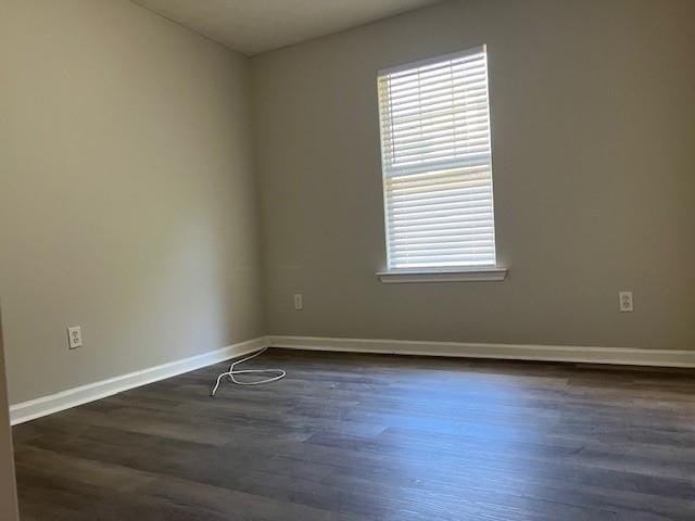 spare room with dark hardwood / wood-style floors