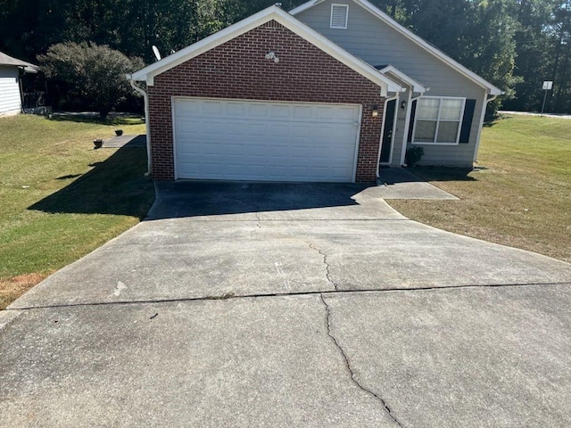 view of front of property with a front yard and a garage