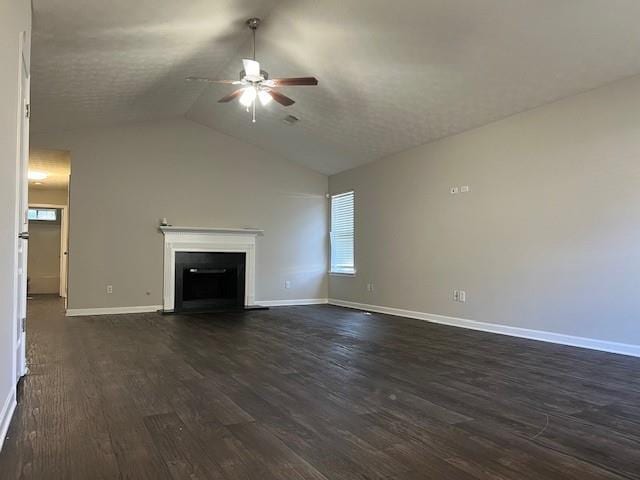 unfurnished living room featuring dark hardwood / wood-style floors, a textured ceiling, vaulted ceiling, and ceiling fan