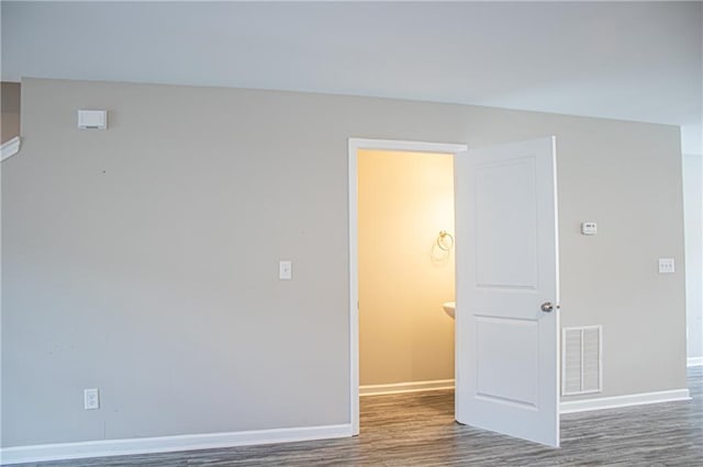 empty room with dark hardwood / wood-style flooring