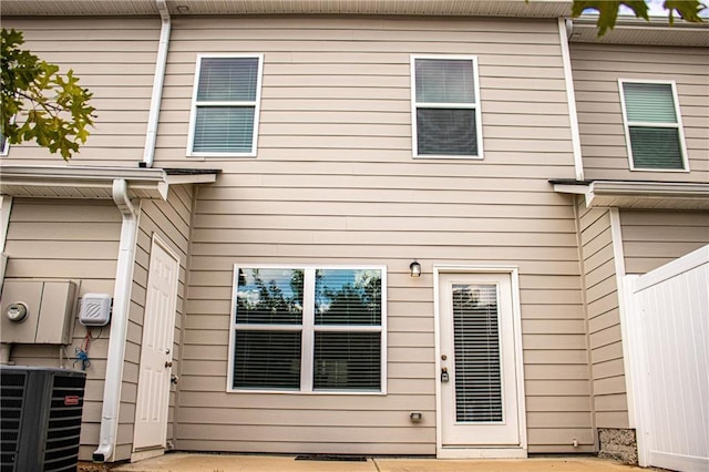 rear view of property featuring central AC