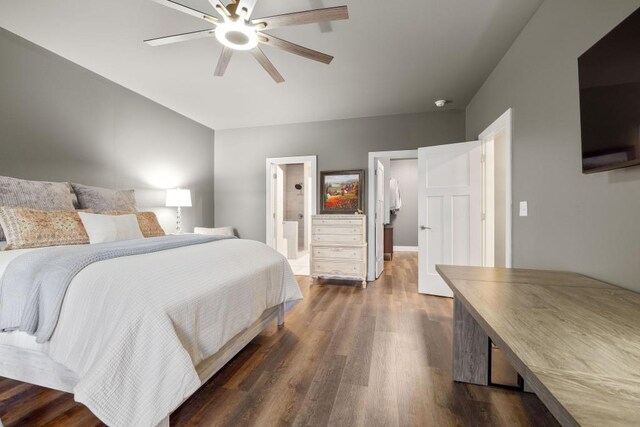 bedroom featuring dark wood-type flooring, ceiling fan, and ensuite bath