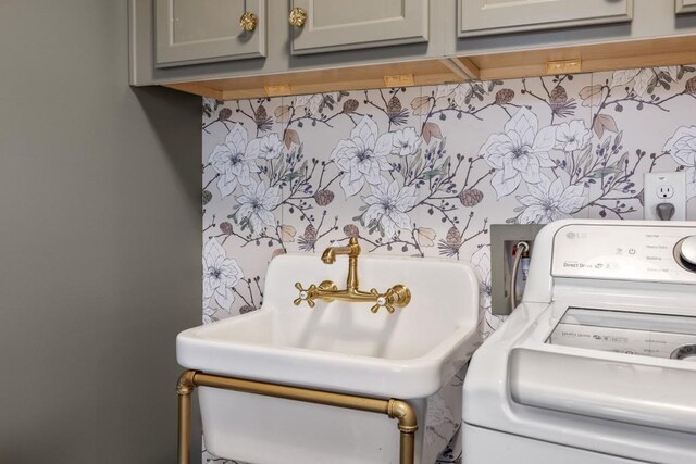 laundry room featuring washer / dryer and cabinet space