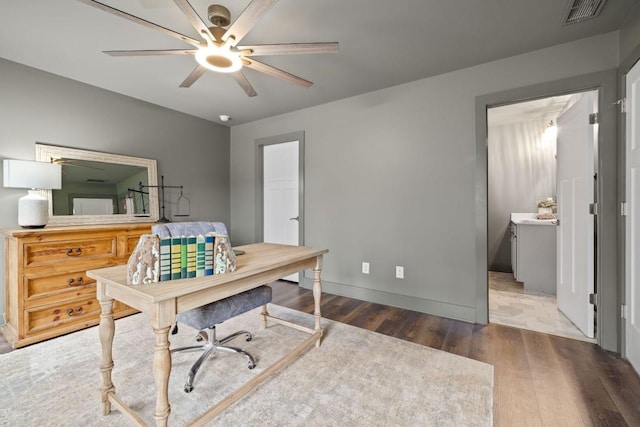 office area featuring a ceiling fan, wood finished floors, and baseboards