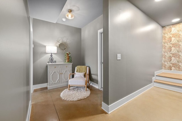 living area with concrete floors and baseboards