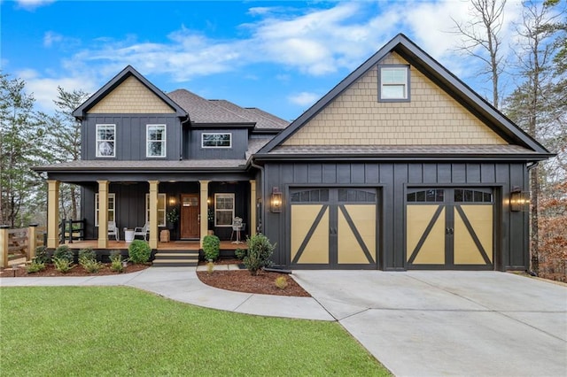 craftsman inspired home with board and batten siding, driveway, covered porch, a garage, and a front yard