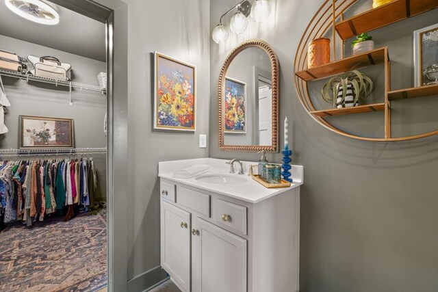 bathroom with vanity and a spacious closet
