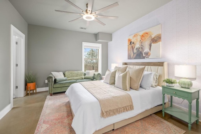 bedroom featuring finished concrete floors, baseboards, and a ceiling fan