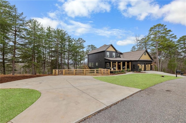 view of front facade featuring concrete driveway, covered porch, and a garage