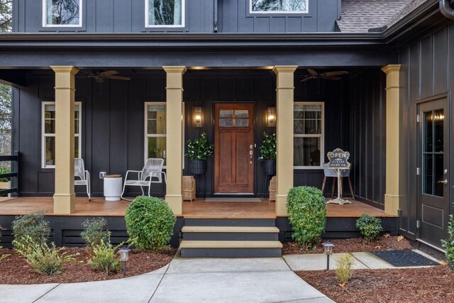 doorway to property with board and batten siding and a porch