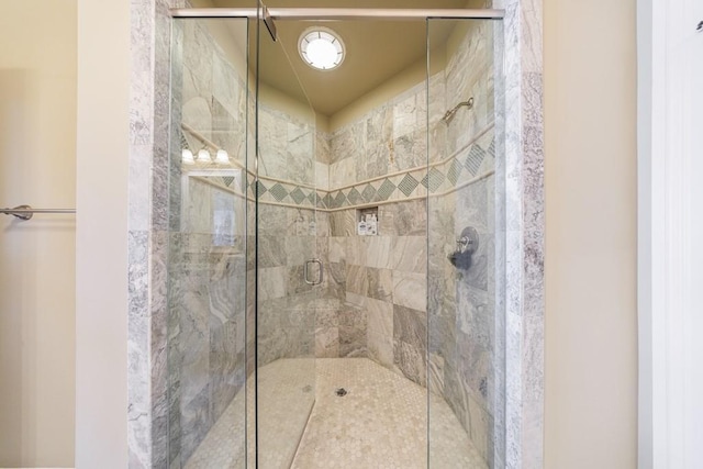 bathroom featuring a shower with door