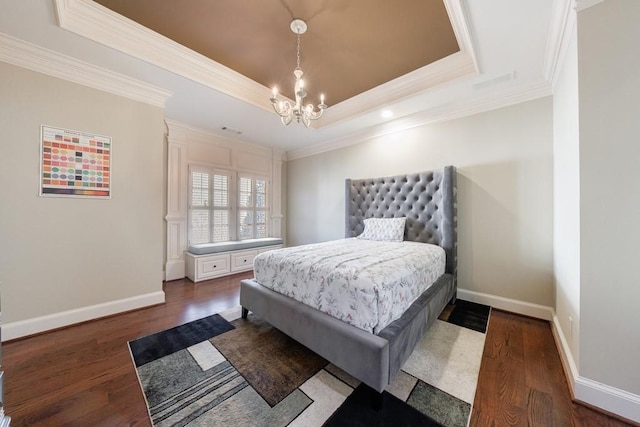 bedroom with a tray ceiling, a chandelier, dark wood-type flooring, and ornamental molding