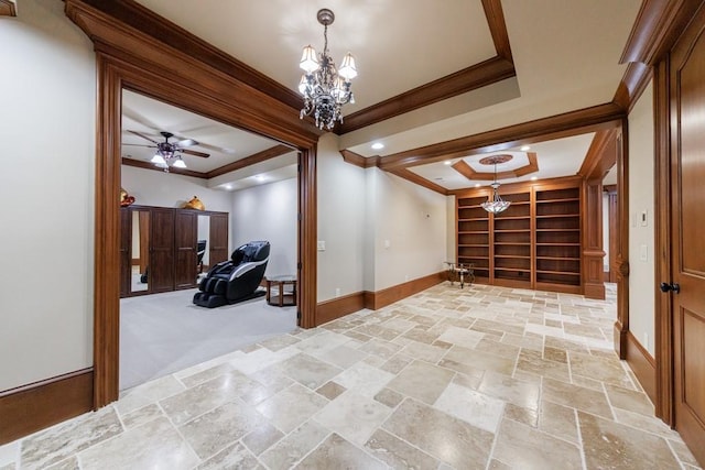 additional living space featuring ceiling fan with notable chandelier and built in shelves