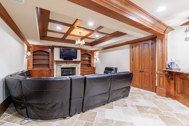 living room featuring a stone fireplace, ornamental molding, coffered ceiling, and a notable chandelier