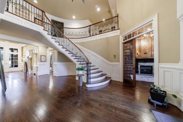 interior space with a towering ceiling and hardwood / wood-style flooring