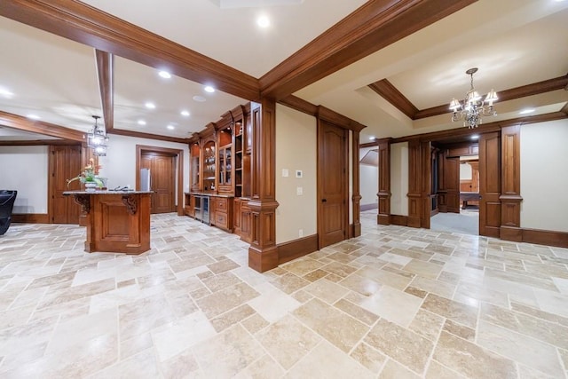 bar with a chandelier, light stone counters, hanging light fixtures, and ornamental molding