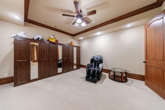 sitting room featuring light colored carpet, ceiling fan, and ornamental molding