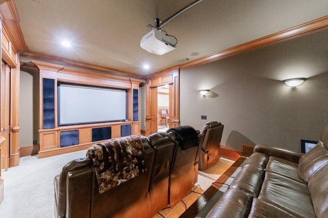 cinema room featuring crown molding and light carpet