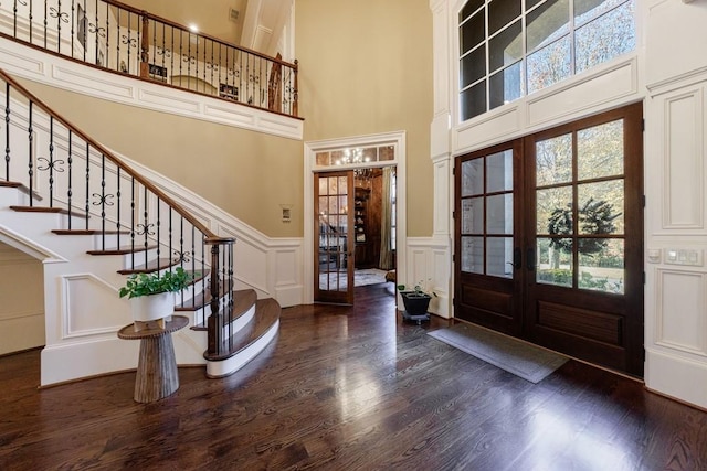 entryway featuring dark hardwood / wood-style floors, a high ceiling, and french doors