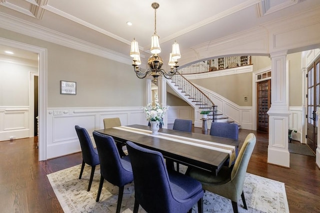 dining room with a chandelier, dark hardwood / wood-style flooring, ornamental molding, and decorative columns