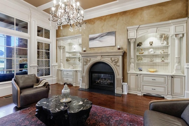 living room with crown molding, a chandelier, and dark hardwood / wood-style floors