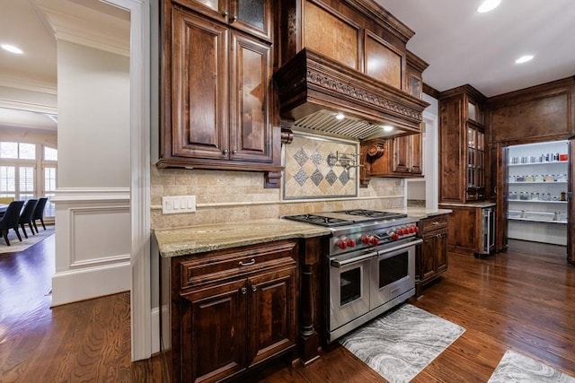 kitchen featuring dark hardwood / wood-style flooring, double oven range, custom range hood, and ornamental molding