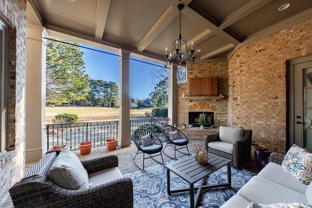 sunroom with beamed ceiling, an outdoor stone fireplace, and a chandelier