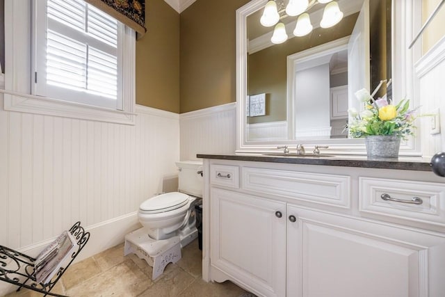 bathroom with vanity, toilet, and crown molding