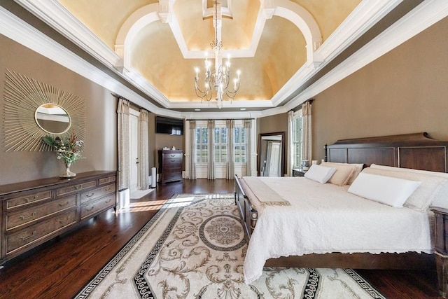 bedroom with a notable chandelier, wood-type flooring, crown molding, and a tray ceiling