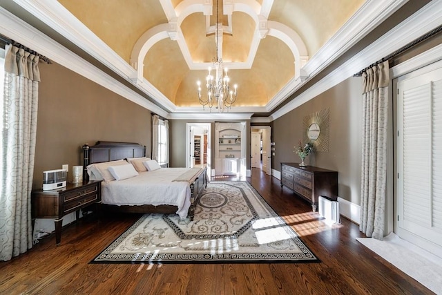 bedroom featuring a raised ceiling, crown molding, dark wood-type flooring, and a notable chandelier