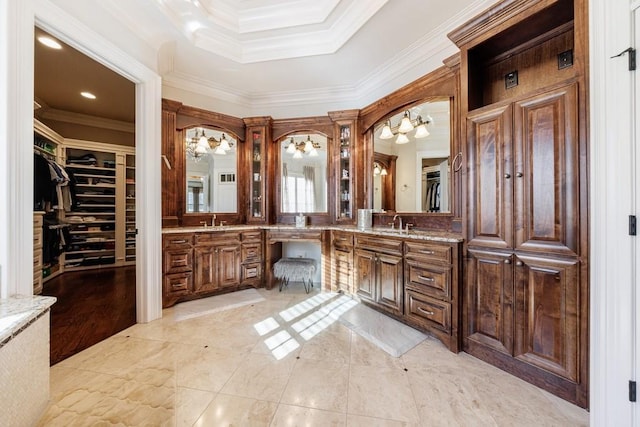 bathroom featuring crown molding, vanity, wood-type flooring, and an inviting chandelier