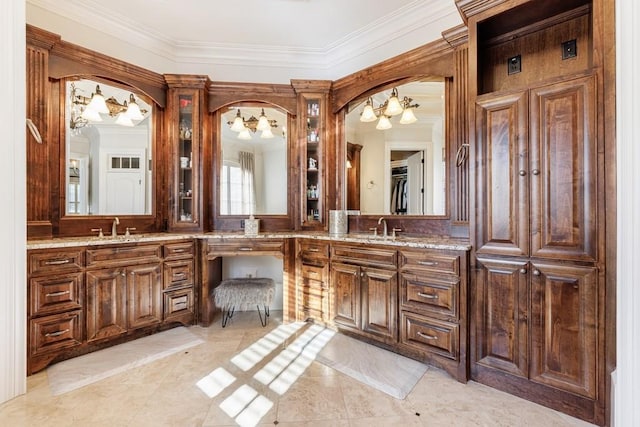 bathroom with crown molding, tile patterned flooring, vanity, and a notable chandelier