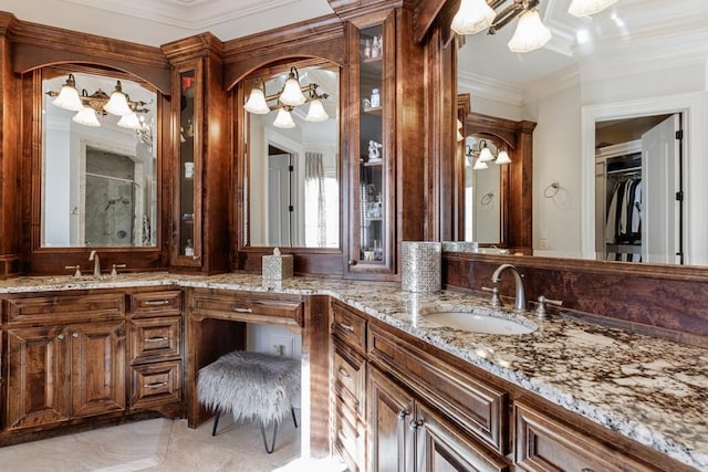 bathroom featuring vanity, a shower, and crown molding