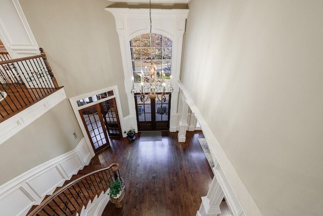 foyer featuring french doors, dark hardwood / wood-style flooring, and a high ceiling