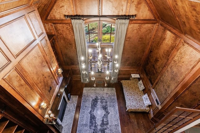 interior details with hardwood / wood-style floors and wood walls